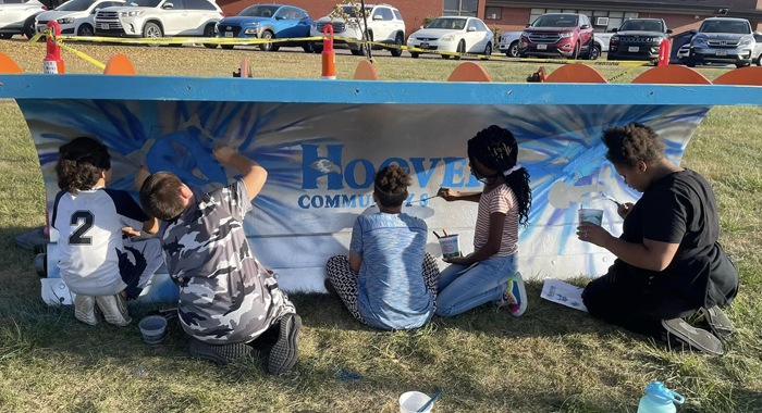Students at Hoover paint a snowplow.