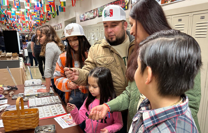 Family looking at coins during Garfield Culture Fair.