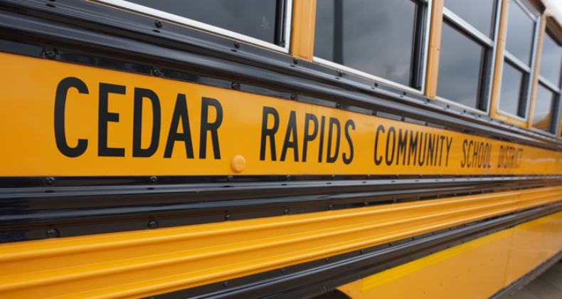 Outside of a school district bus that says, Cedar Rapids