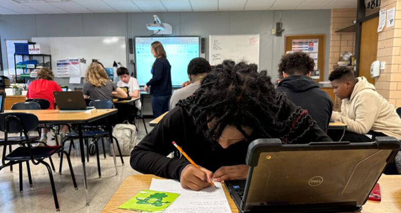 High School Students learning in classroom.