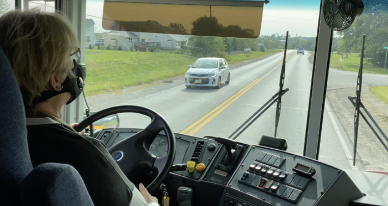 School bus driver driving a bus route.