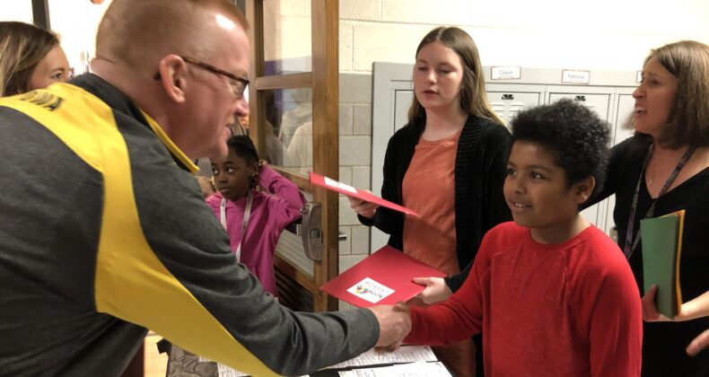 man shaking student's hand