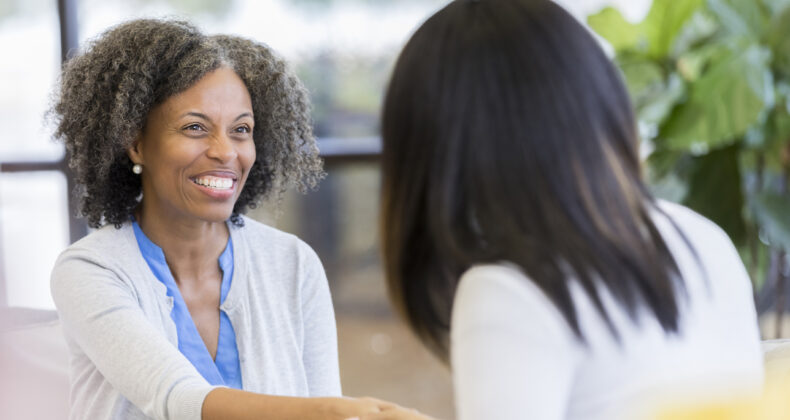 teacher greets female parent