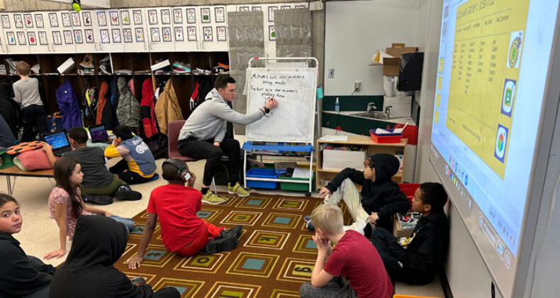 Students gathered around a teacher.