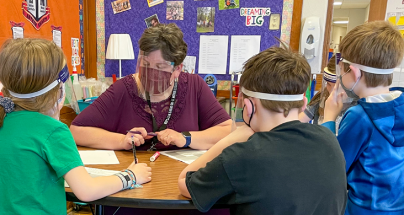 Teacher and students at Arthur working together in a small group